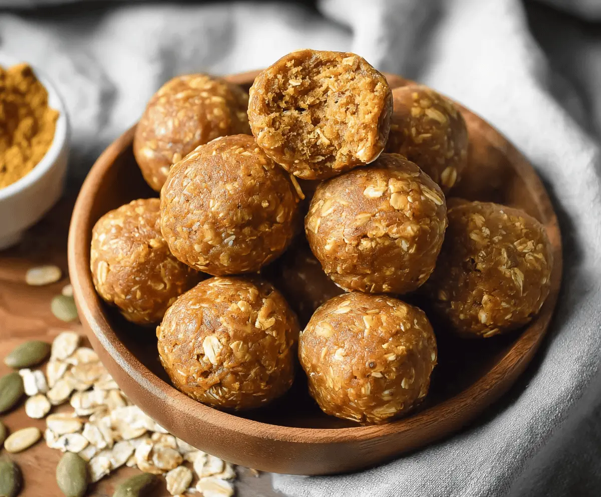 Healthy pumpkin spice protein balls on a white plate, garnished with cinnamon and pumpkin seeds, perfect for a nutritious snack