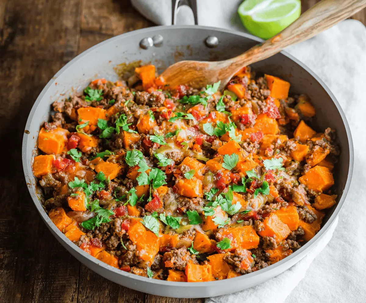 Delicious sweet potato and ground beef skillet with colorful vegetables served in a skillet bowl