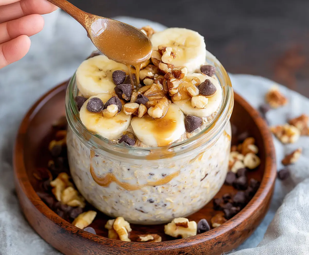 Creamy Chunky Monkey Overnight Oats with bananas, walnuts, and chocolate chips in a glass jar for a healthy breakfast