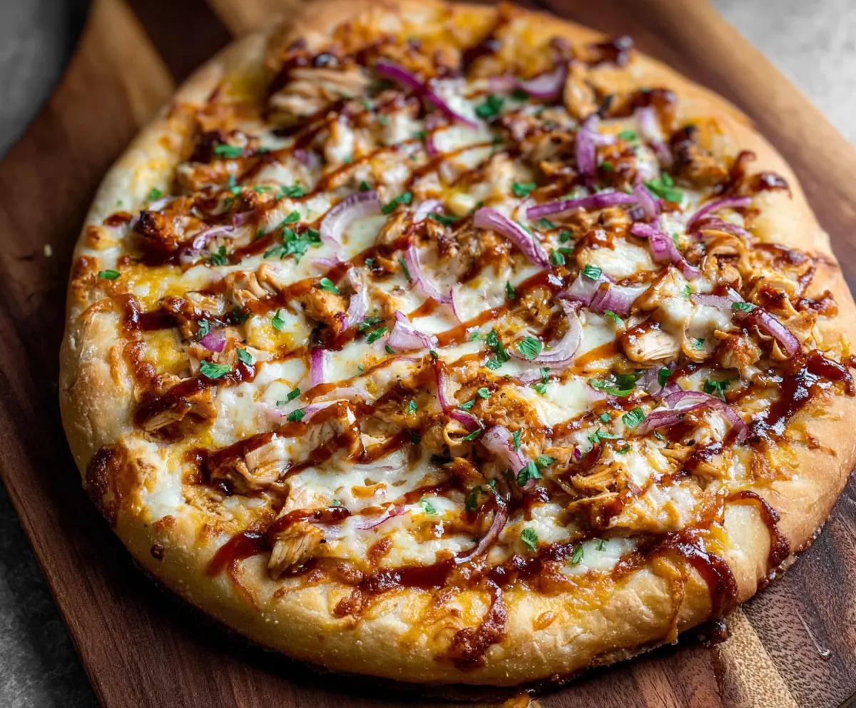 Delicious BBQ Chicken Pizza topped with melted cheese and barbecue sauce on a crispy crust.