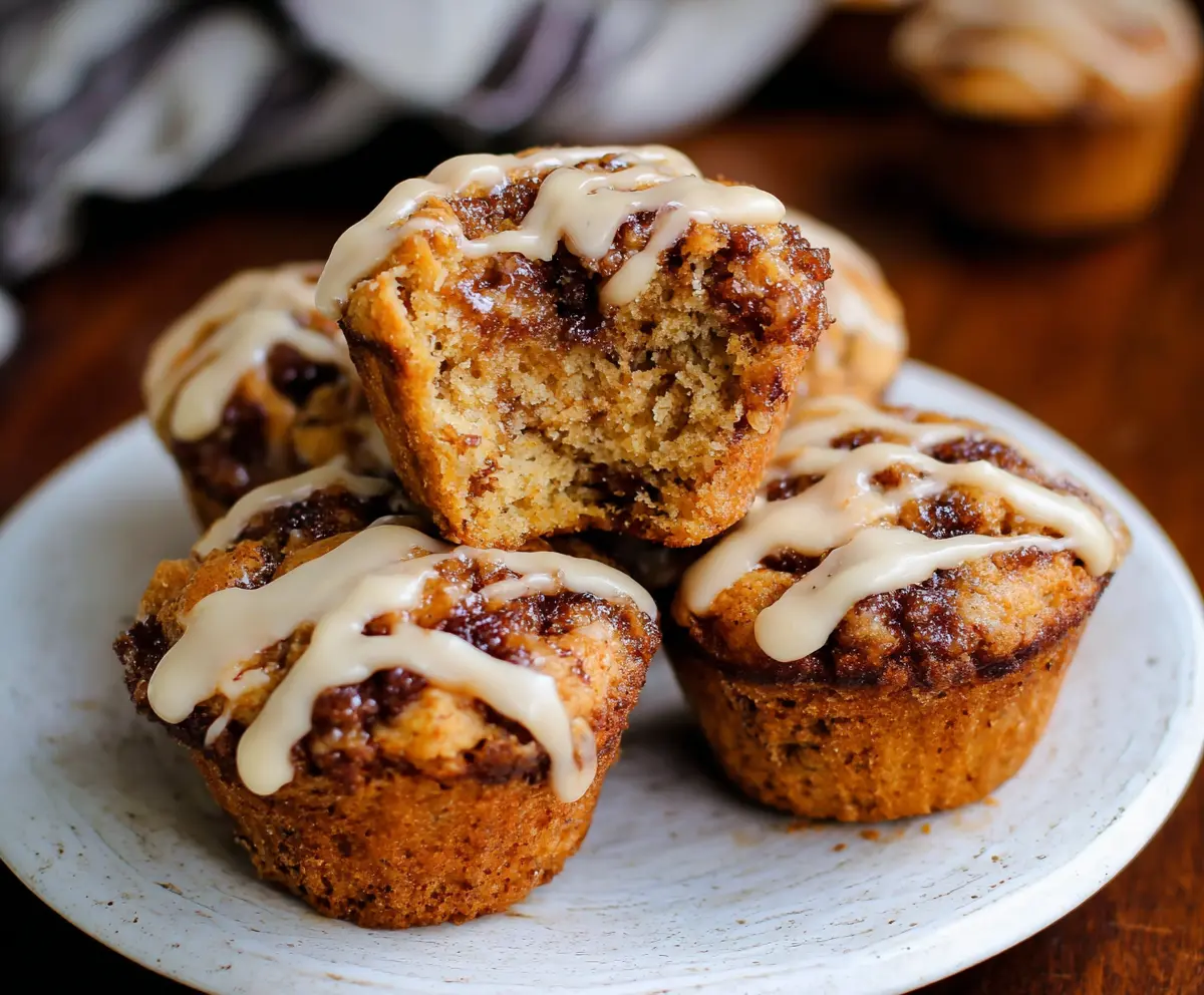 Delicious cinnamon roll protein muffins topped with frosting for a healthy breakfast treat