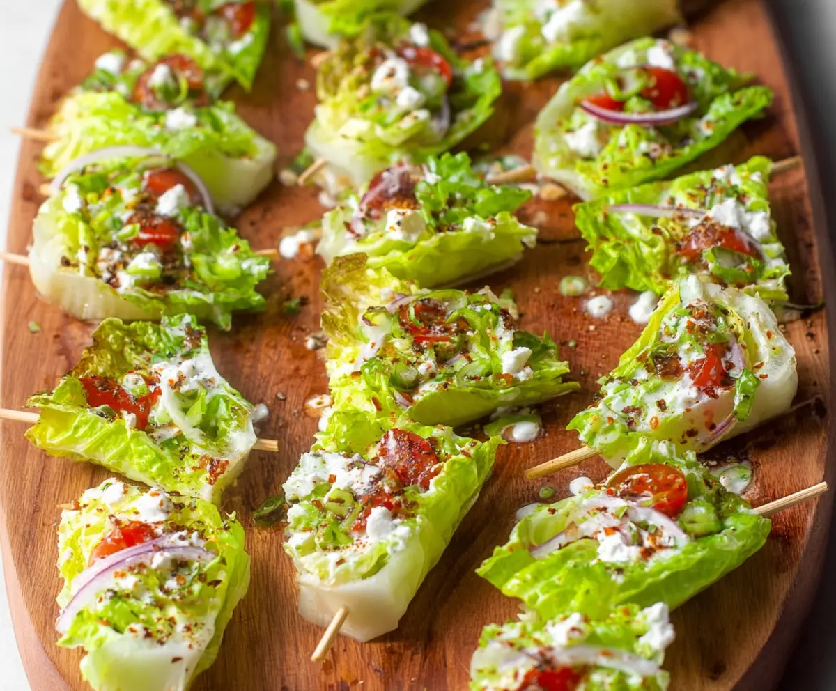 Delicious lettuce wedge bites with fresh toppings and creamy dressing, perfect for a light appetizer