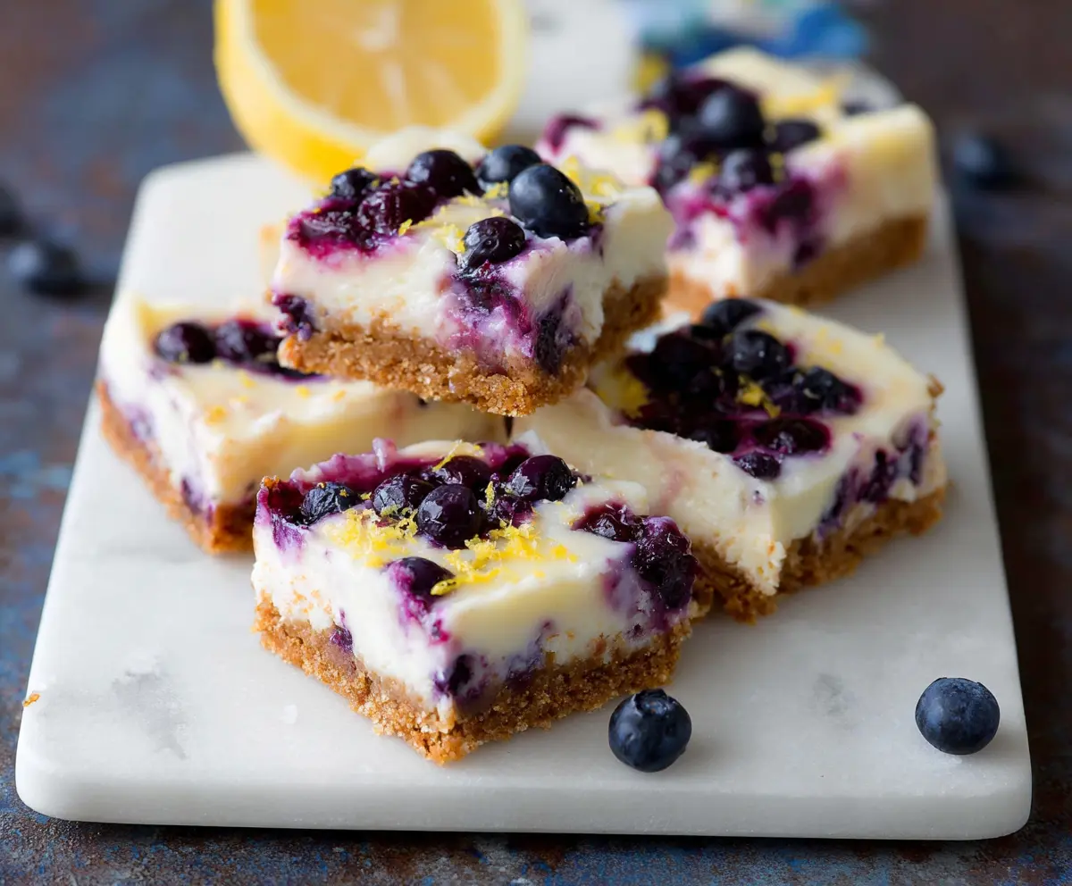 Delicious blueberry lemon cheesecake bars with a golden crust and bright fruit topping.